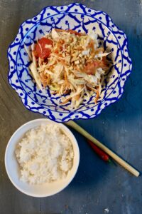 Thai-style som tum cabbage slaw made with shredded cabbage as a green papaya substitute, served with grilled chicken and rice