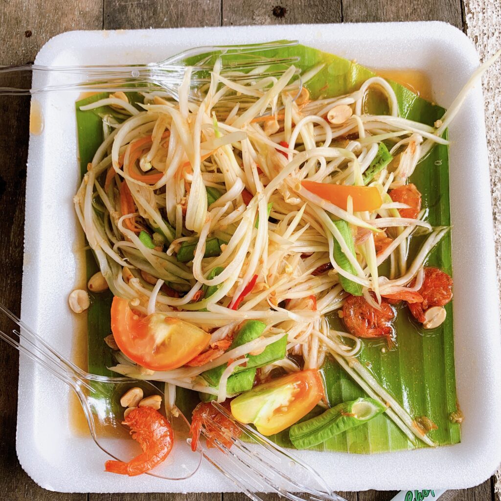 A plate fo som tum thai salad from a street vendor